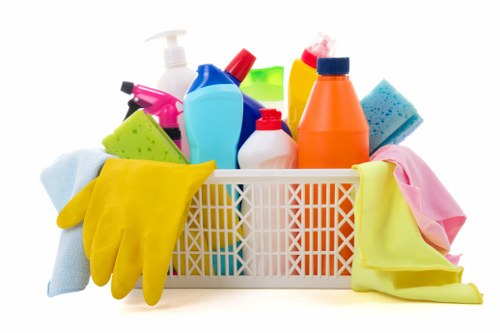 Eco-friendly office cleaning supplies on a workspace
